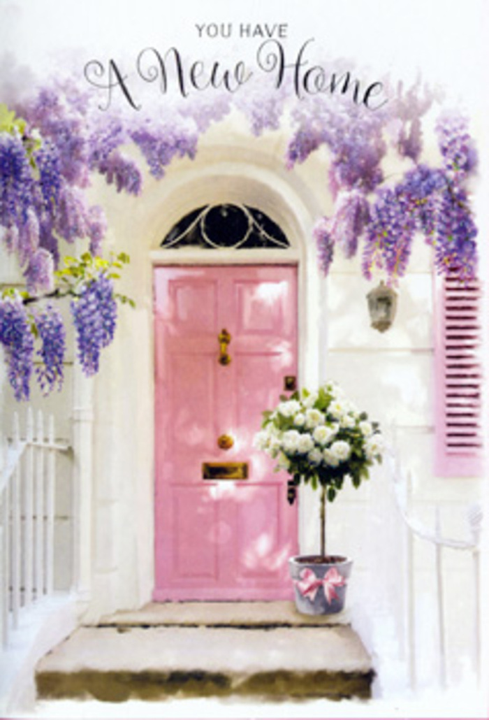 The scene shows a front doorway that feels like a hidden gem just off the main streets of Marks Gate, where neighbours might pause to admire the flowers on their evening walk. A charming door, painted in a soft, rosy pink, forms the heart of the image. Its surface catches the light in a gentle sheen, surrounded by crisp whitewashed walls and a subtly coloured shutter that seems to invite daylight in. Above and around the doorway, mature wisteria winds and curls, its woody stems supporting lavish clusters of lavender-toned blossoms. Each bloom droops slightly, creating natural, fragrant curtains that soften the architecture and bring a whisper of an English cottage garden to this Marks Gate setting. On the doorstep below, a grey tin bucket sits squarely and confidently, brimming with cream and white roses crafted into a lush bouquet. The roses appear freshly opened, their petals plush and layered like folded silk, accented with soft green foliage that adds life and movement to the arrangement. Around the base of the bucket, a satin-like ribbon in blush pink has been tied with care, its ends trailing gracefully over the step, echoing both the door and the wisteria's romantic hues. Gentle sunlight washes across the scene, highlighting petal edges and casting soft shadows that suggest a calm afternoon, perhaps just as the moving boxes have been unpacked. The overall mood is one of delicate excitement and comfort-a florist's visual blessing for new beginnings in Marks Gate, ideal for congratulating someone as they settle into their new address with a doorway that instantly feels like home.